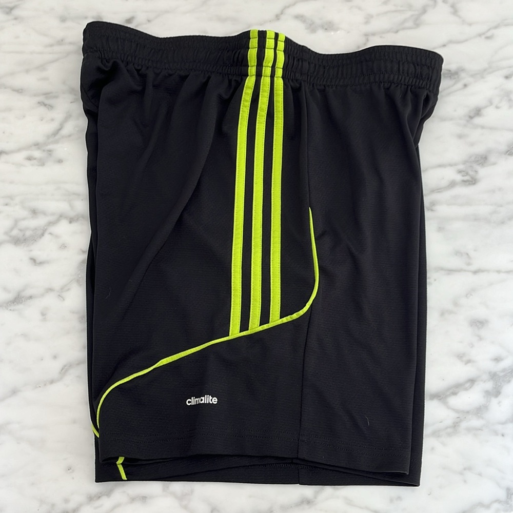 Adidas black shorts; green stripes
